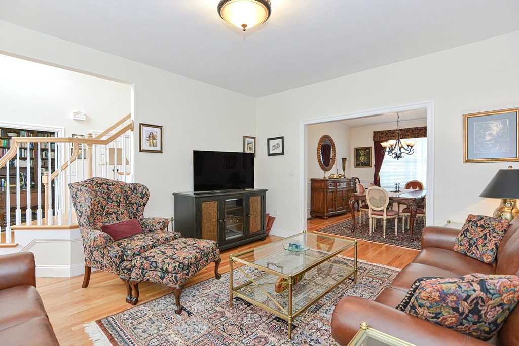 1 Ridgewood Street Ashland, MA 01721 - Photo 3 of 30 a living room with furniture a rug and a flat screen tv