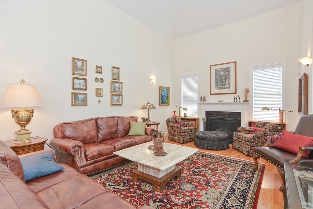 1 Ridgewood Street Ashland, MA 01721 - Photo 10 of 30 a living room with furniture a rug and a fireplace