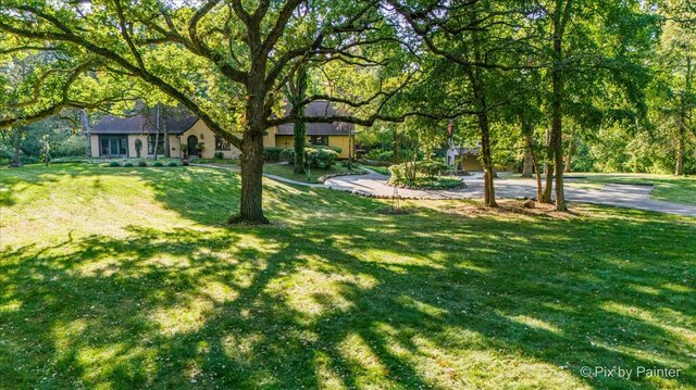 4915 Terra Cotta Road Crystal Lake, IL 60012 - Photo 2 of 93 a backyard of a house with lots of plants and large tree