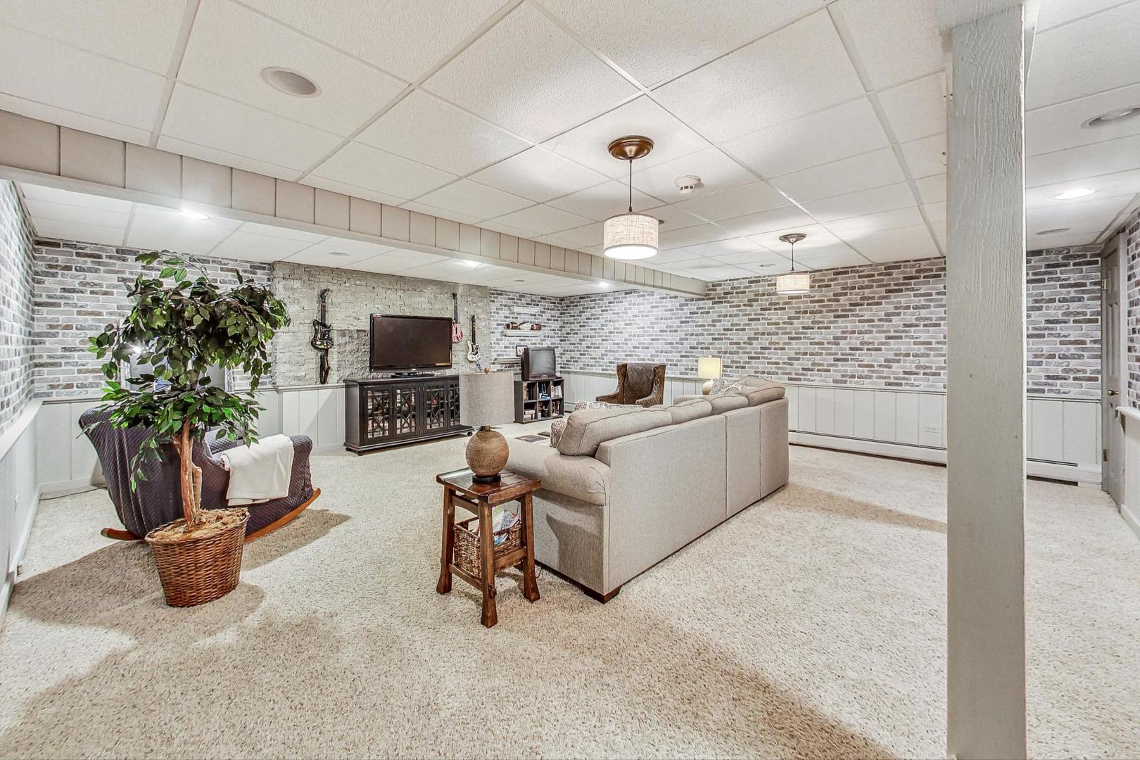 4915 Terra Cotta Road Crystal Lake, IL 60012 - Photo 45 of 93 a living room with furniture and a flat screen tv