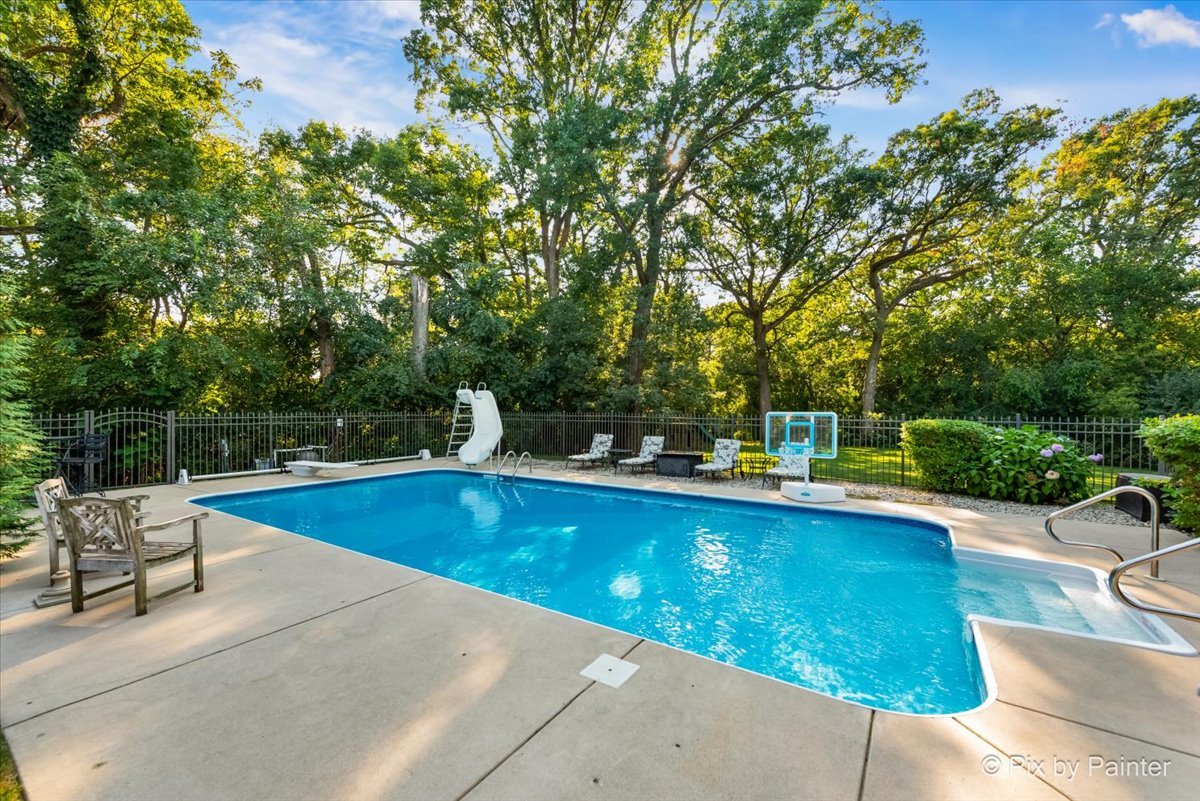4915 Terra Cotta Road Crystal Lake, IL 60012 - Photo 7 of 93 a view of a swimming pool with a table and chairs