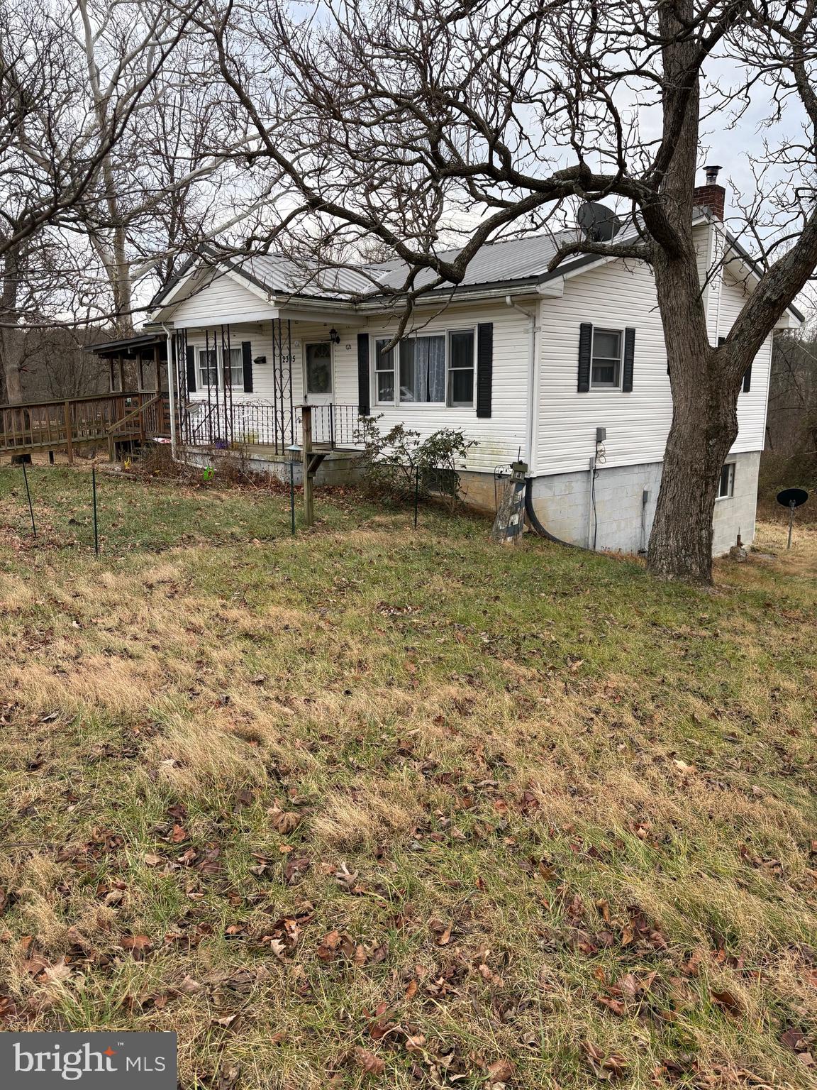 2385 Allensville Road Hedgesville, WV 25427 - Photo 2 of 24 a white house that has a tree in front of it