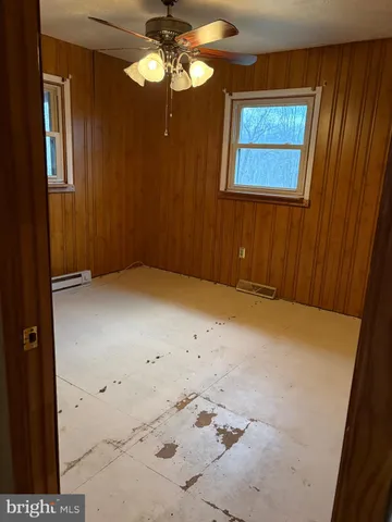 en empty room with fan and window