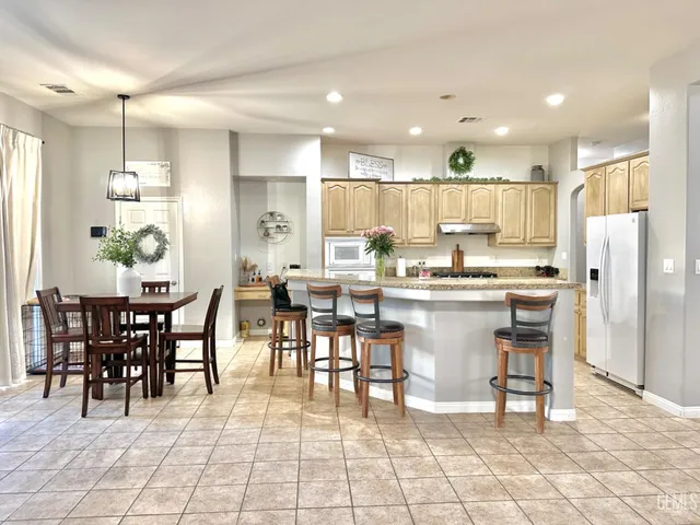 a view of a hallway with wooden floor and a dining room