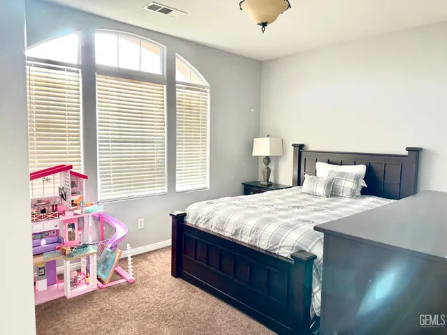 a spacious bathroom with a mirror and a sink