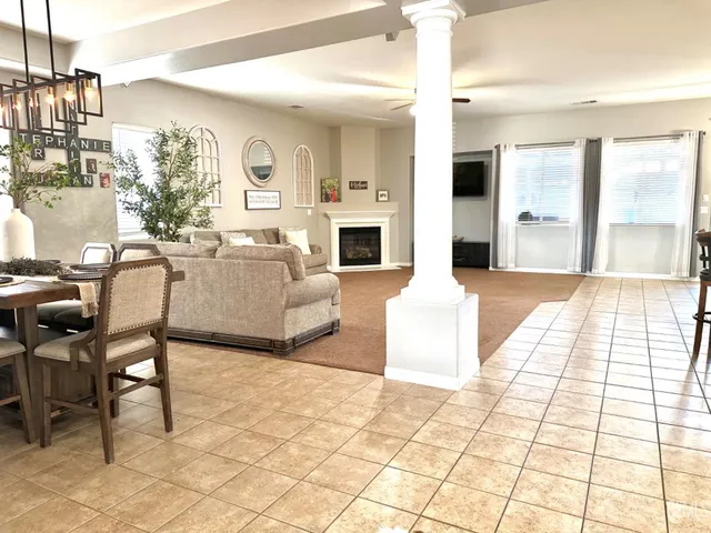 a living room with fireplace furniture and a chandelier