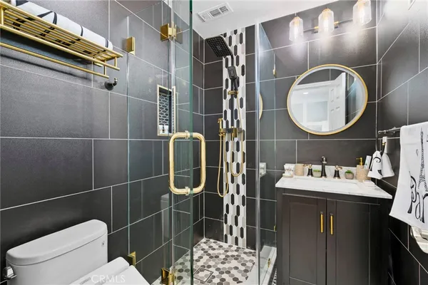 a bathroom with a sink toilet and shower