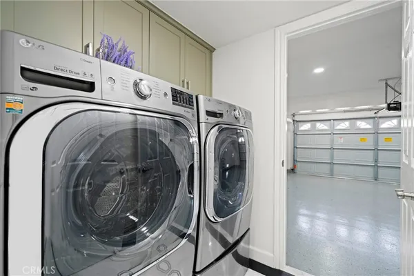a living room with stainless steel appliances furniture and a window