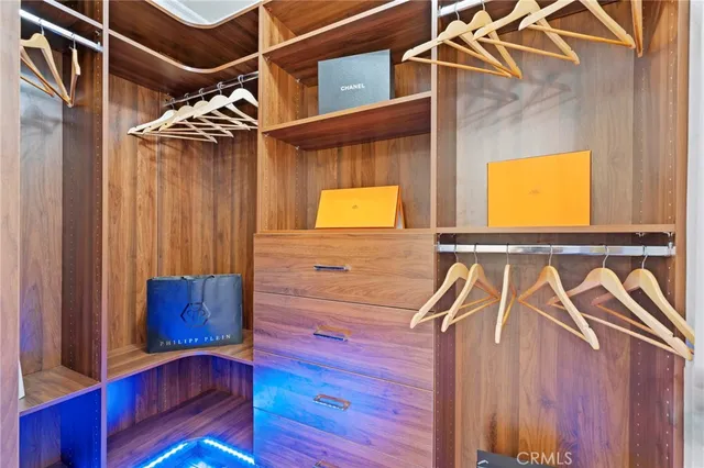 a spacious bedroom with a large bed and a potted plant