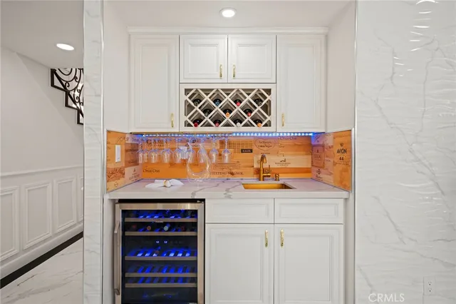 a dining room with furniture a kitchen and chandelier