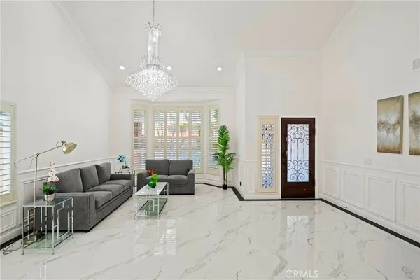 a living room with furniture and a chandelier
