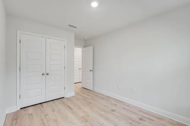a view of an empty room and wooden floor