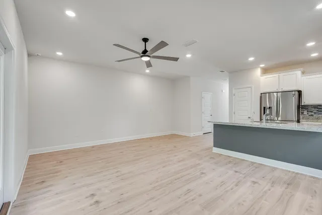 a view of kitchen with wooden floor and window