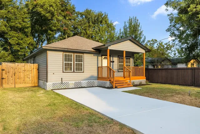 a backyard of a house with wooden fence