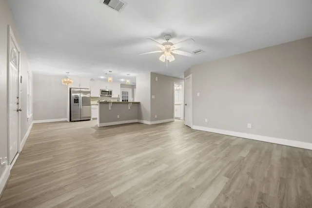 a view of a kitchen with a sink and a refrigerator