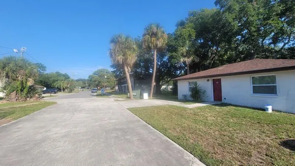 a view of a house with yard and a garage