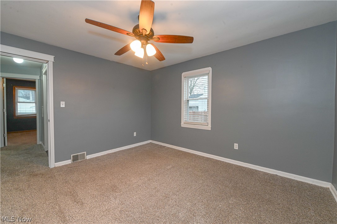 8301 Ackley Road Parma, OH 44129 - Photo 24 of 47 Carpeted spare room featuring ceiling fan