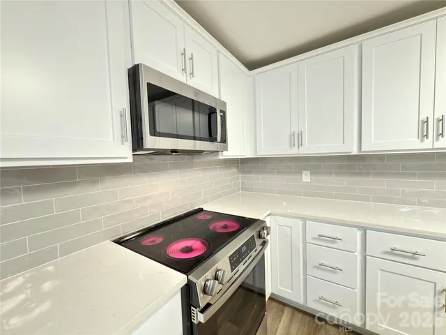 a kitchen with a stove and a microwave