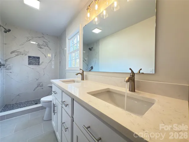 a bathroom with a toilet a sink and shower