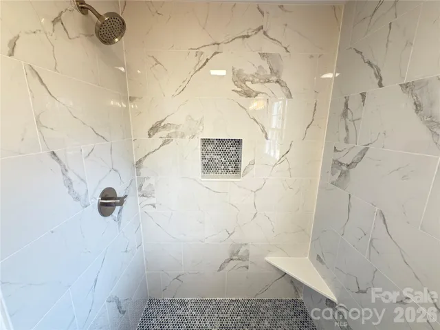 a spacious bathroom with a double vanity sink a mirror and a toilet