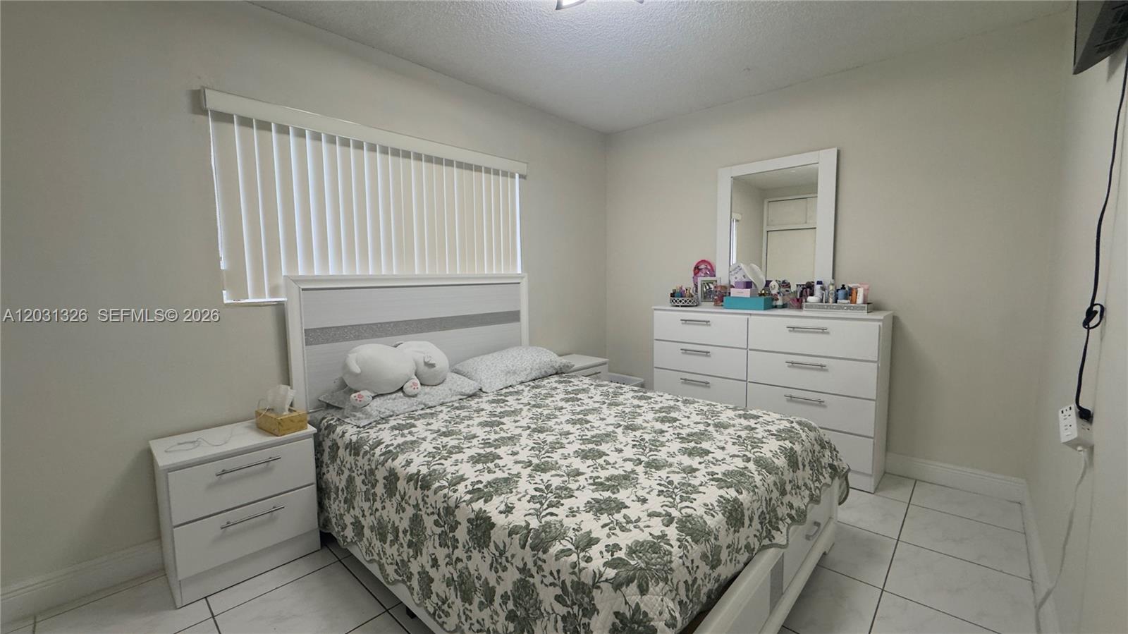 12480 Southwest 189th Street Miami, FL 33177 - Photo 8 of 25 a bedroom with a bed and a dresser