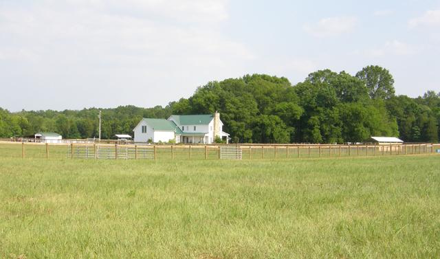 1330 Milltown Road Lewisburg, TN 37091 - Photo 2 of 17 View of the house from one of the paddocks. The 2 car garage has stairs to storage above. Expansion area? Note also the back covered porch.