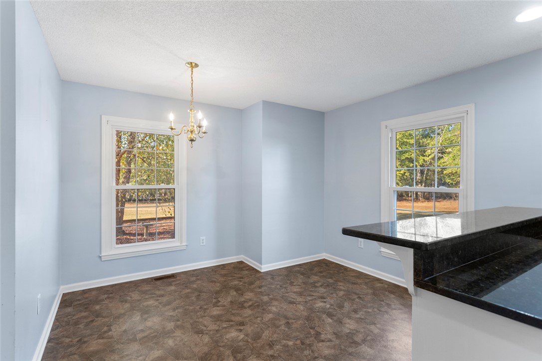 108 Ora Lane Anderson, SC 29625 - Photo 11 of 40 This bright space features natural light, a beautiful chandelier, and ample counter space for entertaining.