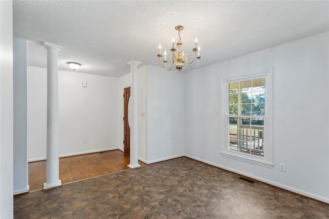 108 Ora Lane Anderson, SC 29625 - Photo 13 of 40 This bright space features a classic chandelier and durable flooring, offering a welcoming atmosphere.