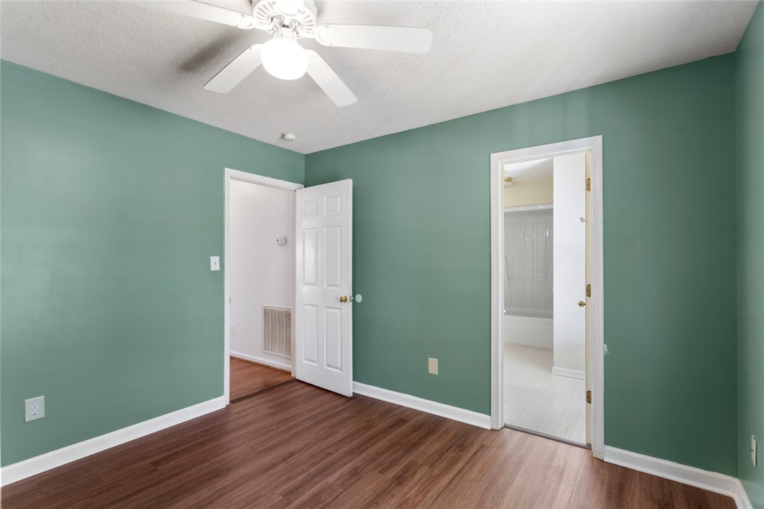 108 Ora Lane Anderson, SC 29625 - Photo 24 of 40 This inviting bedroom features rich wood flooring, a ceiling fan, and offers direct access to a private bathroom.