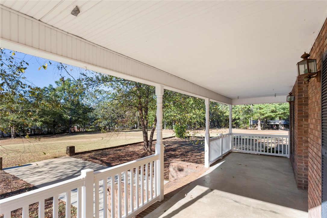 108 Ora Lane Anderson, SC 29625 - Photo 33 of 40 This inviting porch offers tranquil views of the expansive yard, perfect for serene outdoor moments.