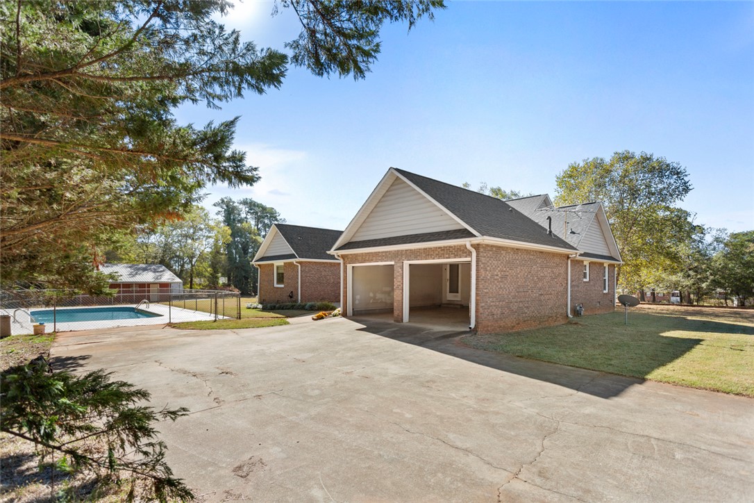 108 Ora Lane Anderson, SC 29625 - Photo 34 of 40 This spacious property offers a large driveway, a multi-car garage, and a refreshing outdoor pool.