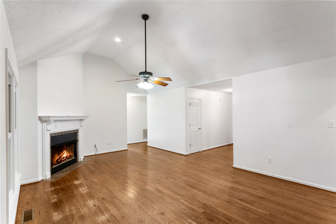 108 Ora Lane Anderson, SC 29625 - Photo 5 of 40 This inviting living space features gleaming hardwood floors and a cozy fireplace, creating an atmosphere of warmth.