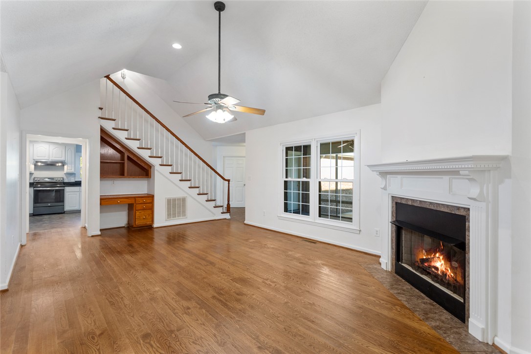 108 Ora Lane Anderson, SC 29625 - Photo 7 of 40 This bright living space features hardwood floors, a fireplace, and an inviting staircase.