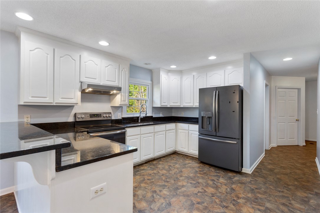 108 Ora Lane Anderson, SC 29625 - Photo 8 of 40 This inviting kitchen boasts a breakfast bar and modern appliances, perfect for everyday living.
