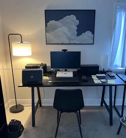 a living room with a table and a lamp