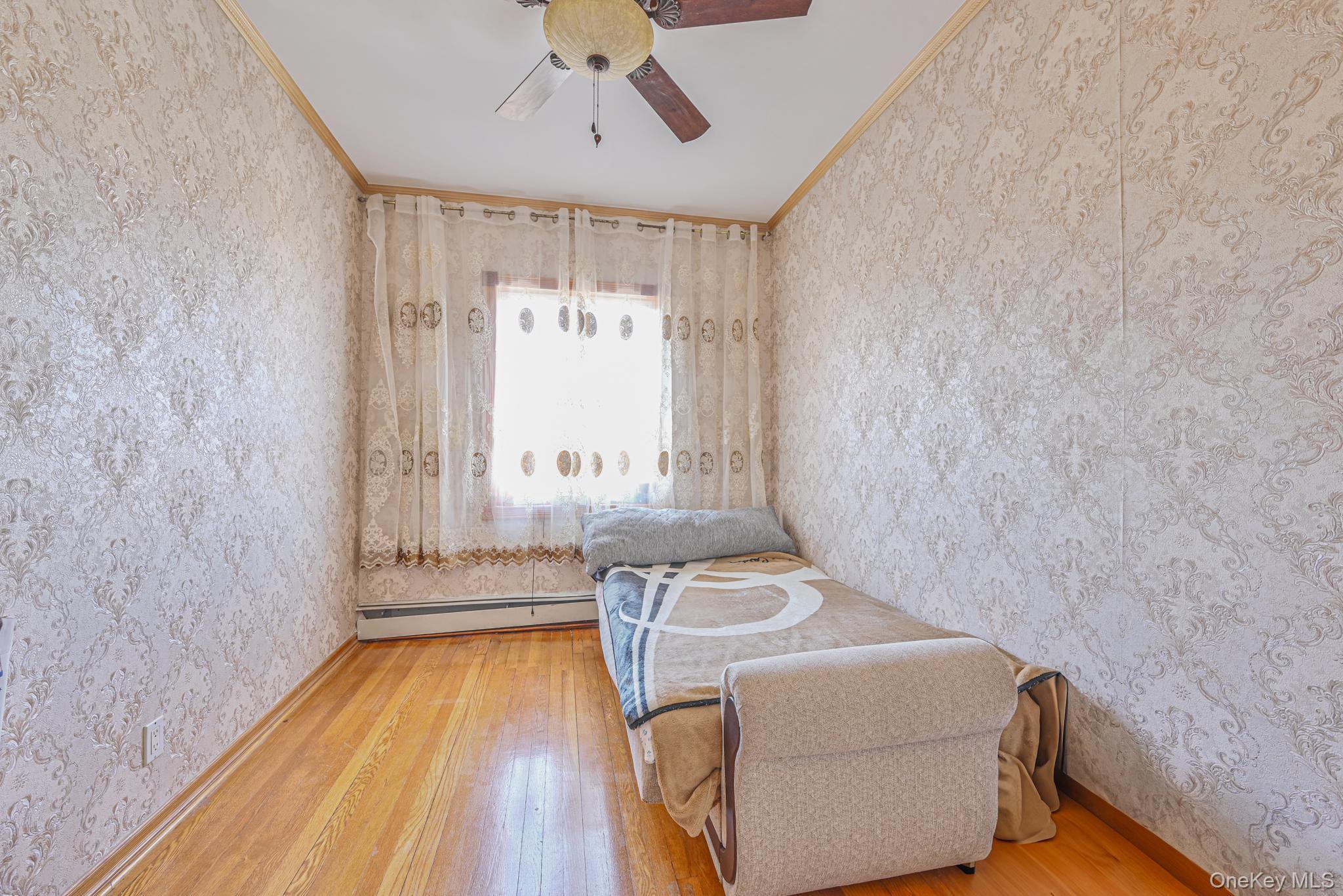 102-01 62nd Road Queens, NY 11375 - Photo 11 of 25 a bedroom with a bed and a window