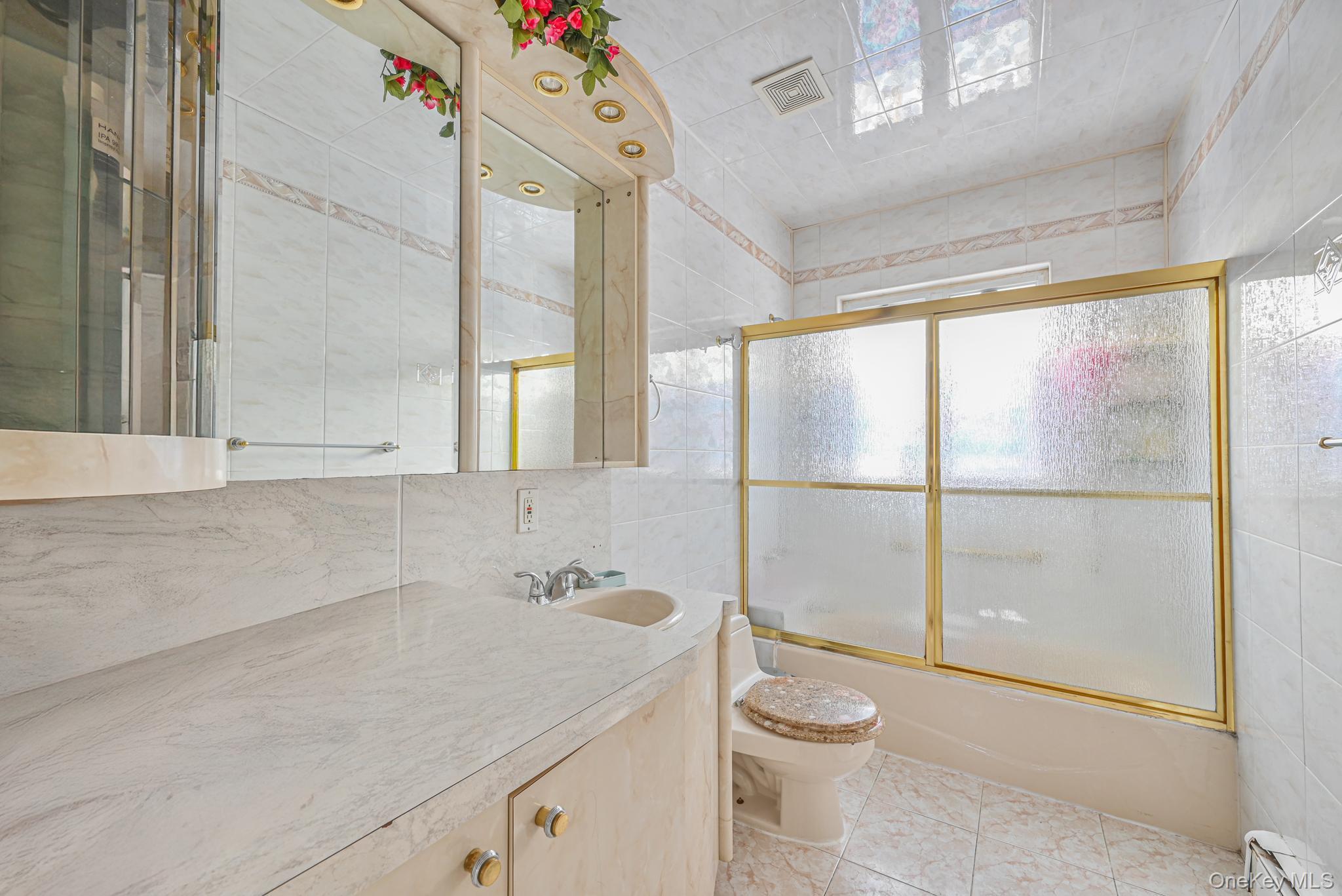 102-01 62nd Road Queens, NY 11375 - Photo 14 of 25 a bathroom with a granite countertop sink a toilet and a shower