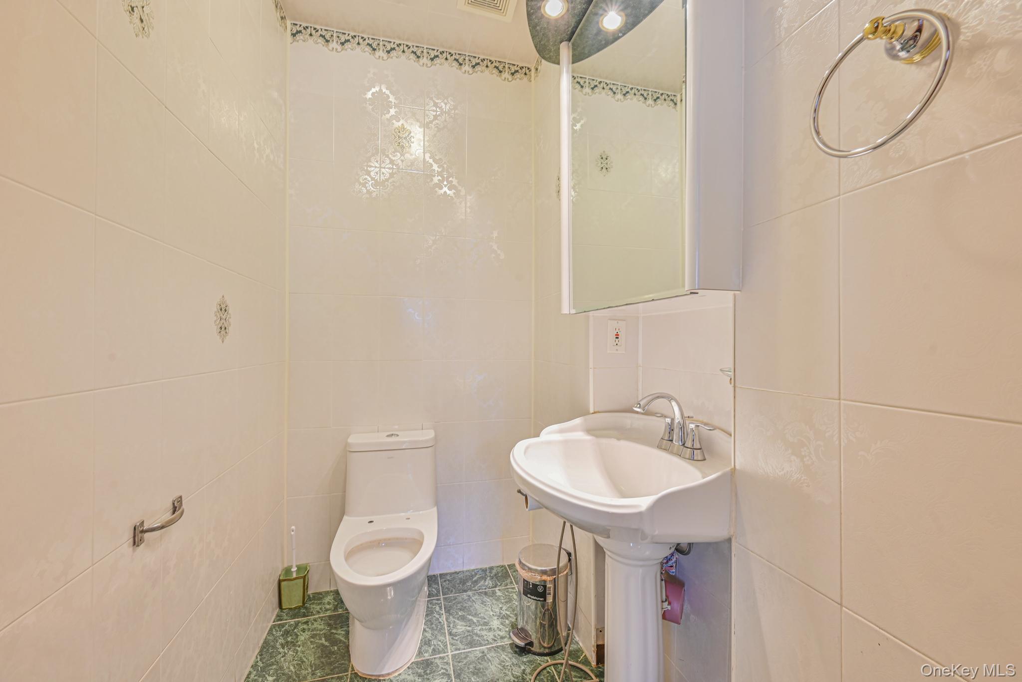 102-01 62nd Road Queens, NY 11375 - Photo 20 of 25 a bathroom with a sink a toilet and shower