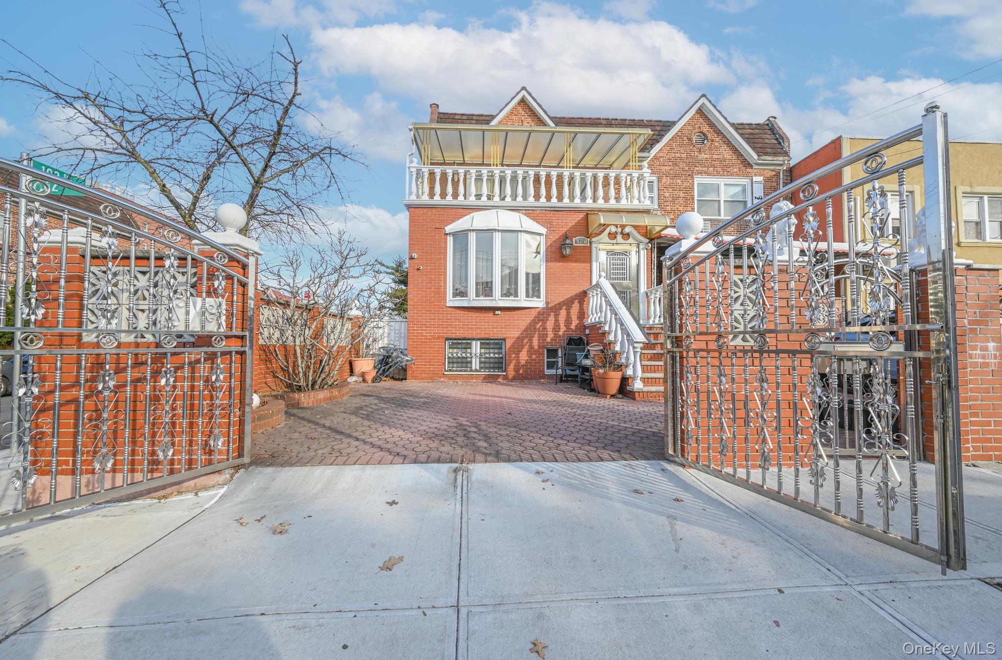 102-01 62nd Road Queens, NY 11375 - Photo 2 of 25 a view of a brick house with iron fence