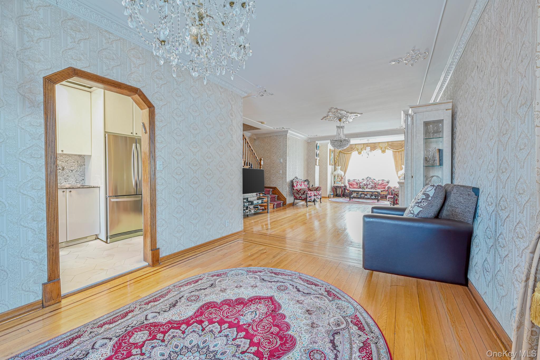 102-01 62nd Road Queens, NY 11375 - Photo 5 of 25 a living room with furniture and a chandelier