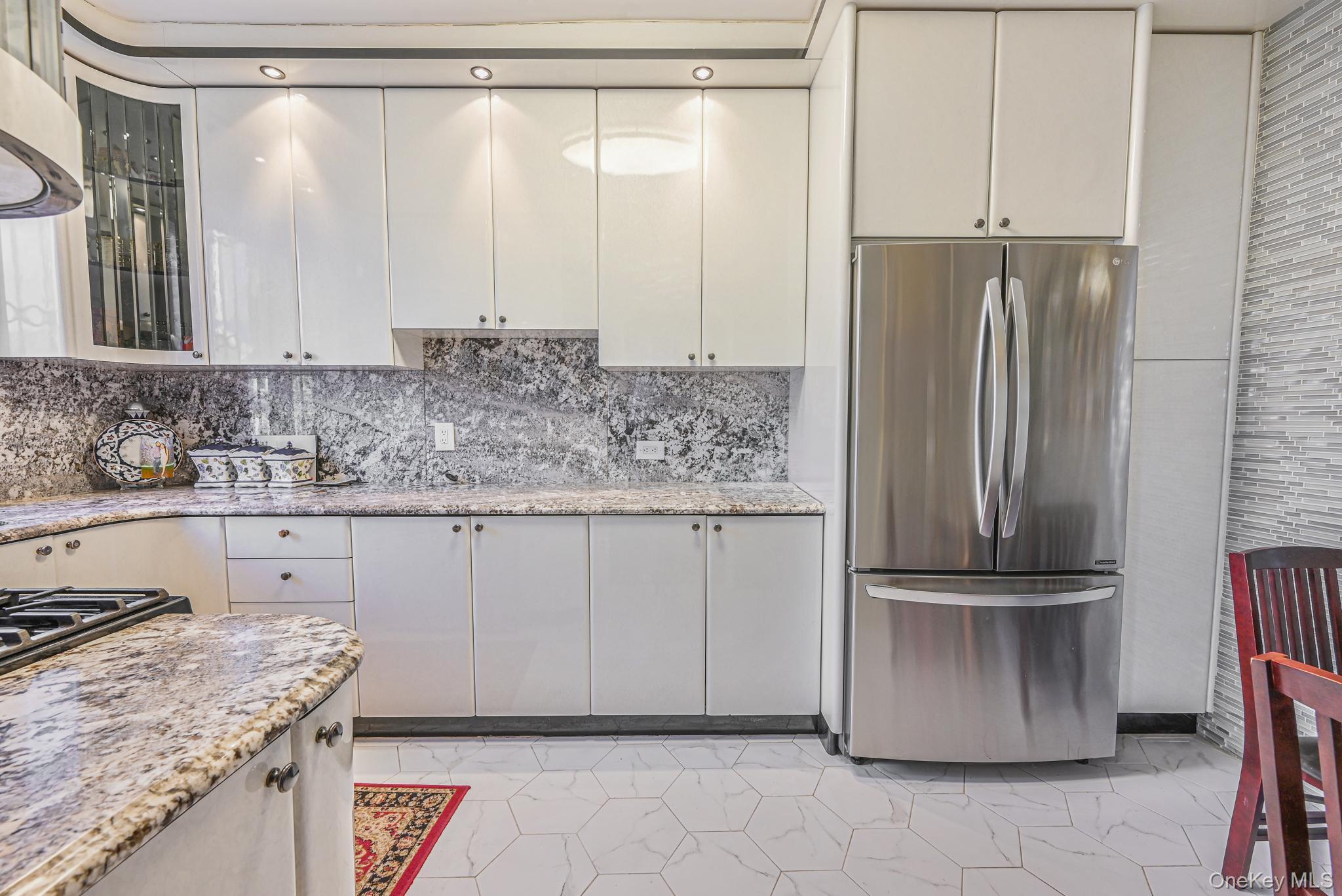 102-01 62nd Road Queens, NY 11375 - Photo 7 of 25 a kitchen with stainless steel appliances granite countertop a refrigerator and a sink