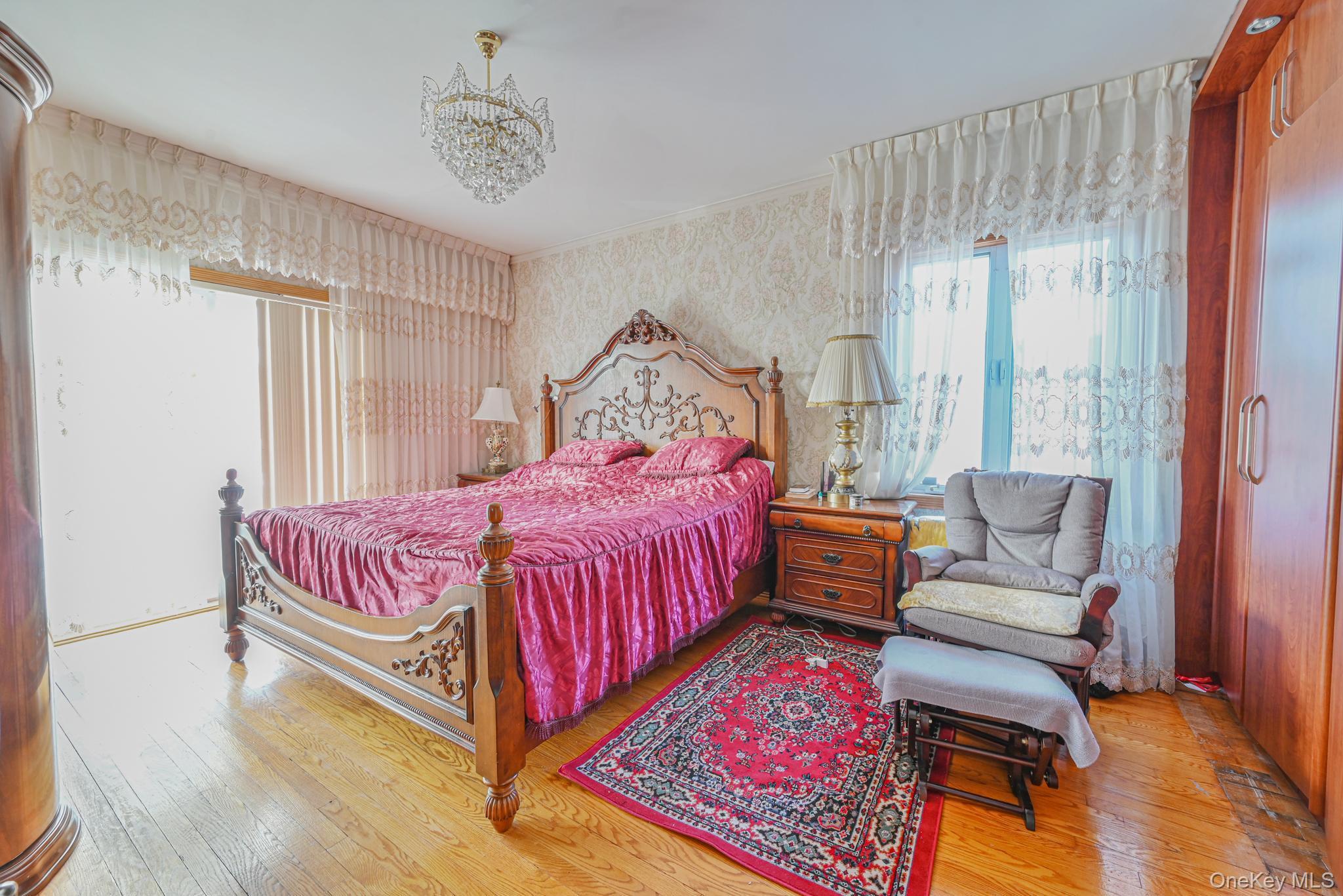 102-01 62nd Road Queens, NY 11375 - Photo 8 of 25 a bedroom with a bed and wooden floor