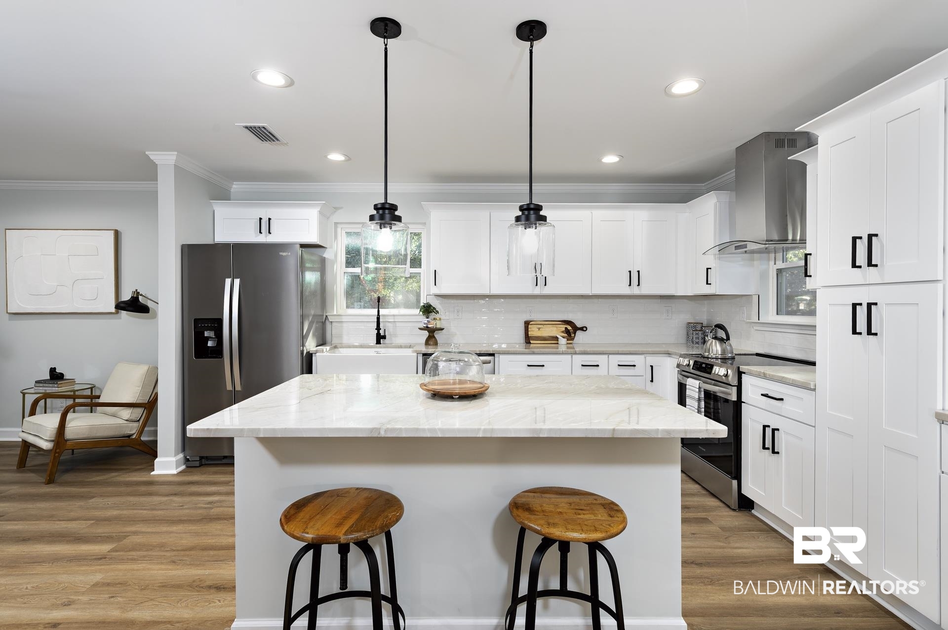 6001 Camp Halls Mill Road Mobile, AL 36619 - Photo 11 of 52 Kitchen featuring stainless steel appliances, a kitchen breakfast bar, a center island, hanging light fixtures, and wall chimney exhaust hood