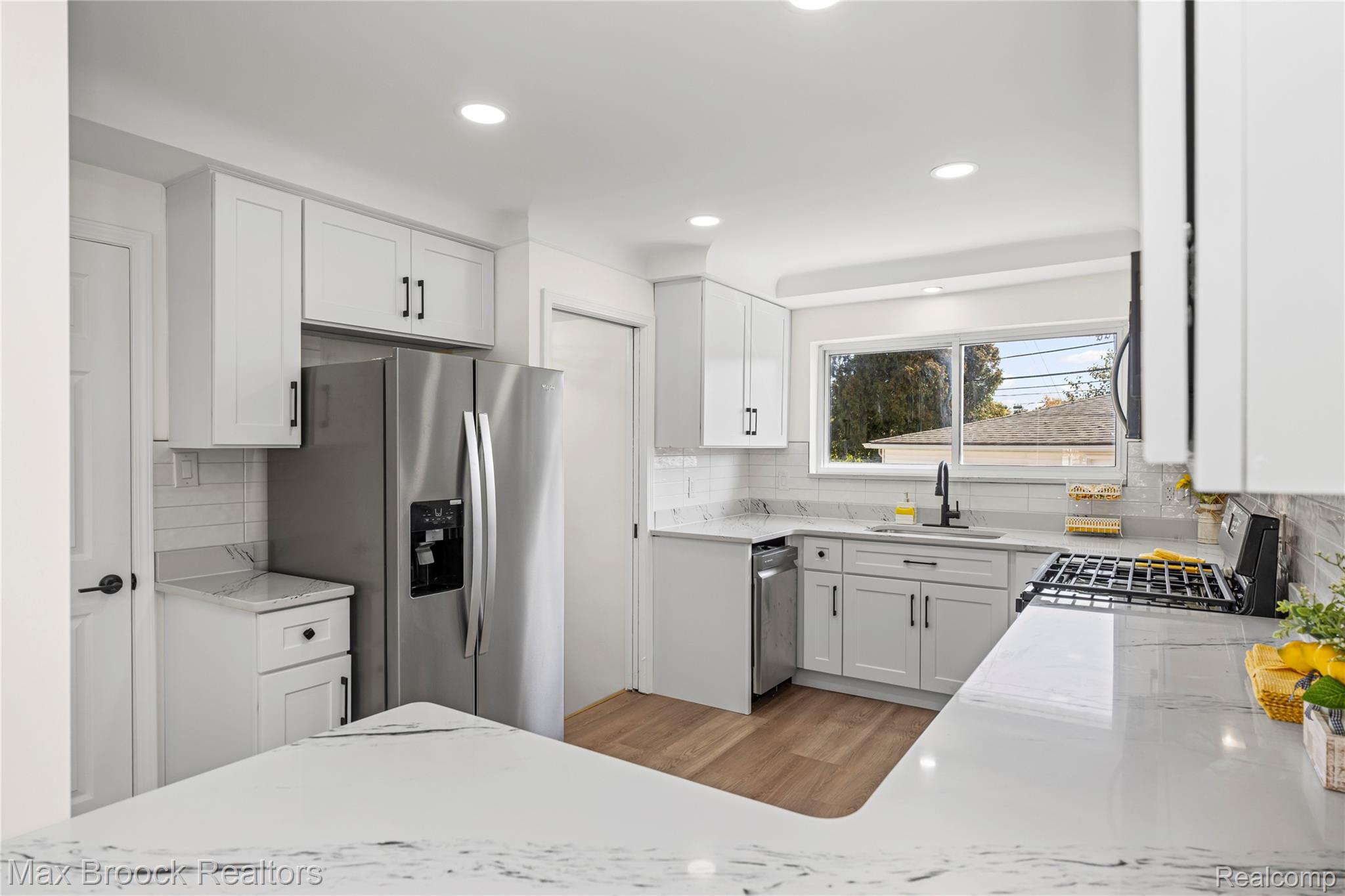 1544 Sheffield Road Birmingham, MI 48009 - Photo 15 of 51 Kitchen featuring white cabinetry, stainless steel appliances, light stone countertops, recessed lighting, and wood finished floors