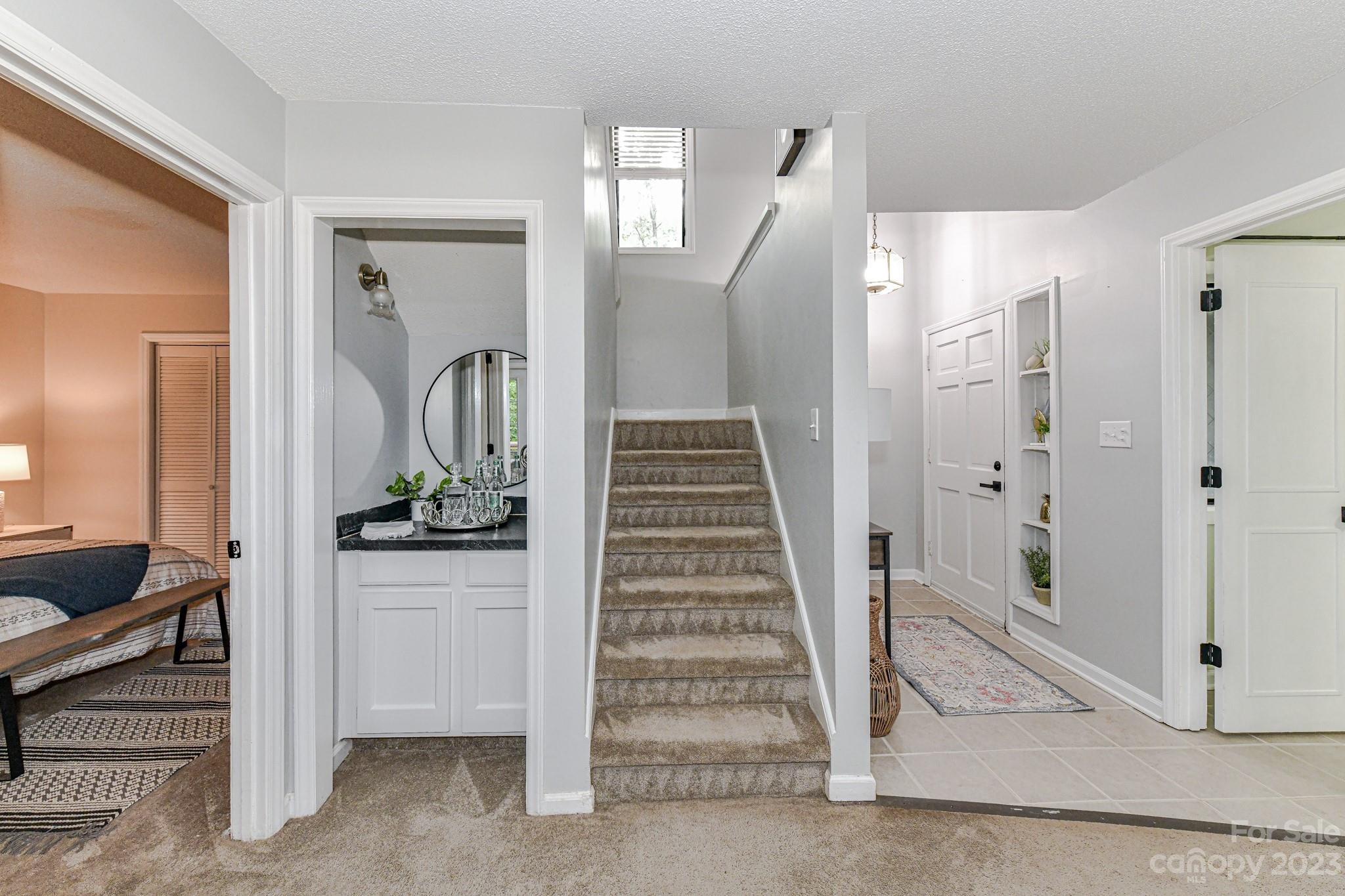 27046 Tidal Way Tega Cay, SC 29708 - Photo 13 of 20 a view of a hallway with wooden floor and staircase