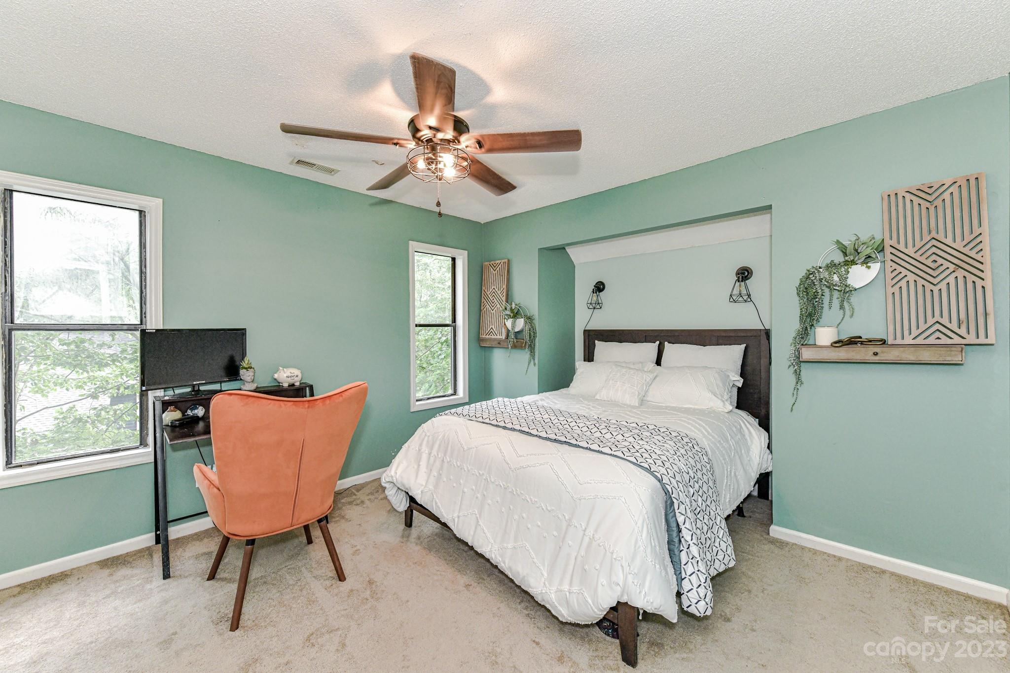 27046 Tidal Way Tega Cay, SC 29708 - Photo 17 of 20 a bedroom with a bed and a window