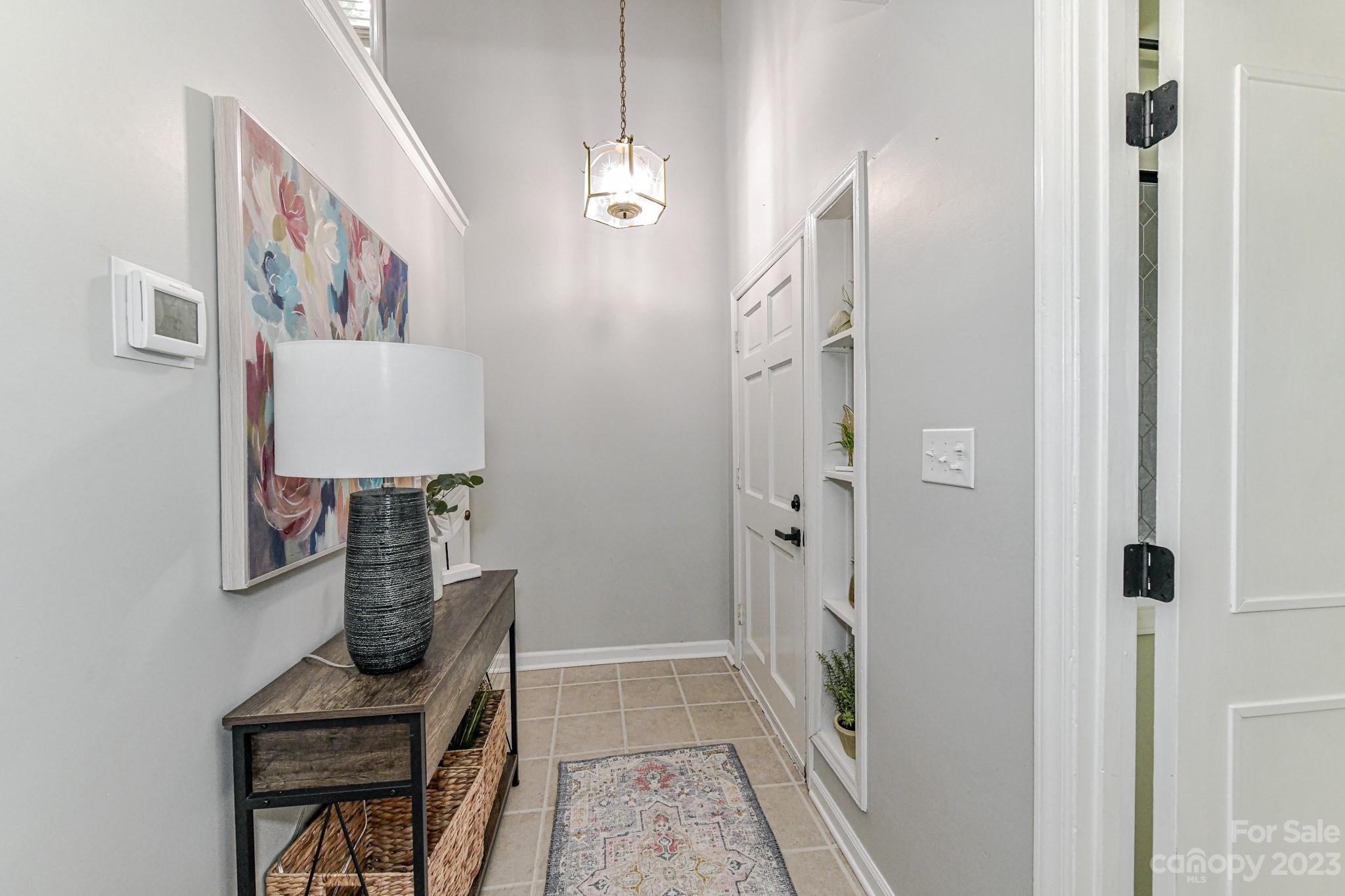 27046 Tidal Way Tega Cay, SC 29708 - Photo 2 of 20 a hallway with painting on the wall and a mirror