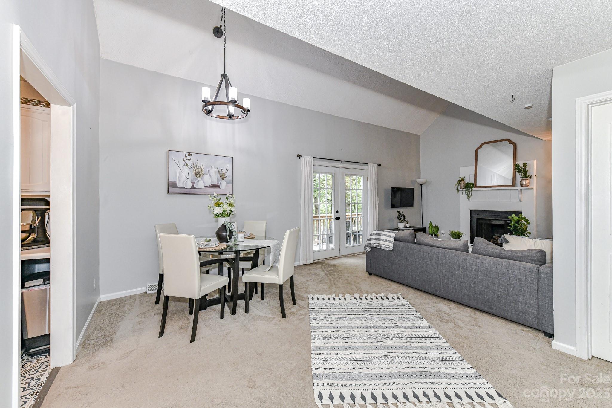 27046 Tidal Way Tega Cay, SC 29708 - Photo 3 of 20 a living room with furniture and a dining table with bookshelf
