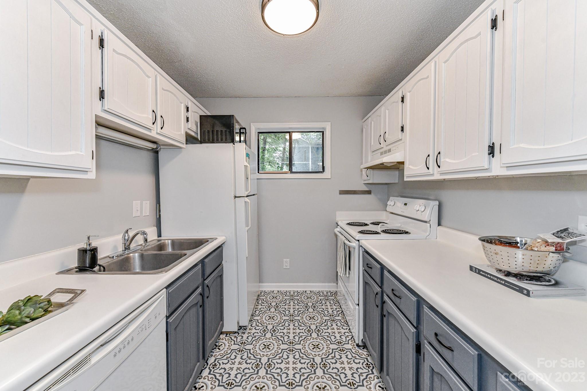 27046 Tidal Way Tega Cay, SC 29708 - Photo 7 of 20 a kitchen with stainless steel appliances granite countertop a sink stove and cabinets