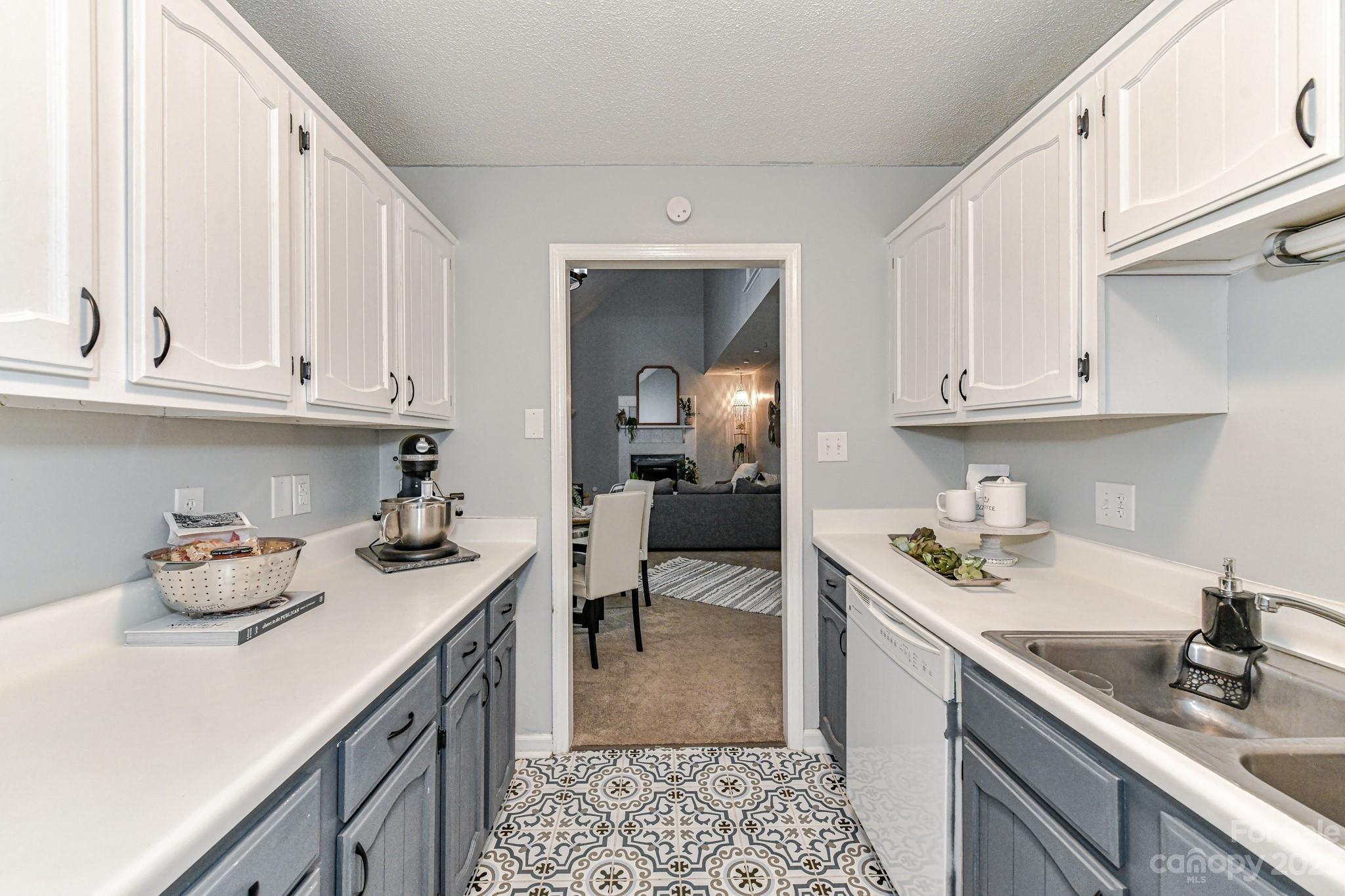 27046 Tidal Way Tega Cay, SC 29708 - Photo 8 of 20 a kitchen with stainless steel appliances granite countertop a sink stove and cabinets